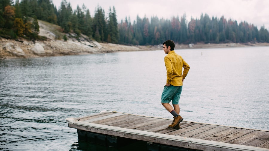 Young man walking on pier at Shaver Lake, California, USA