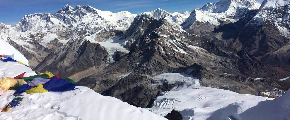 A snow-covered mountain range with peaks and glaciers.