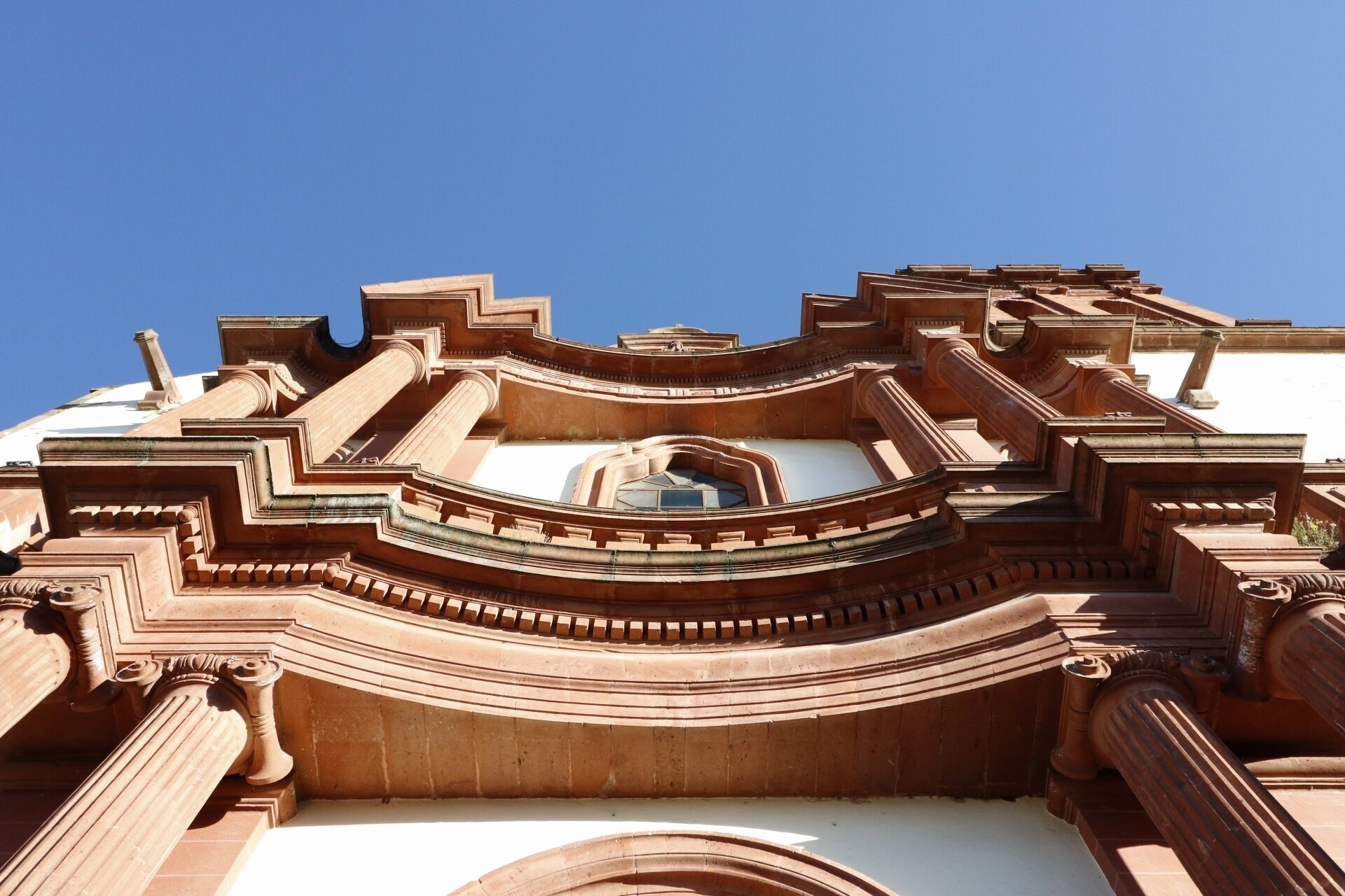 A detailed architectural structure with ornate carvings and a central dome.