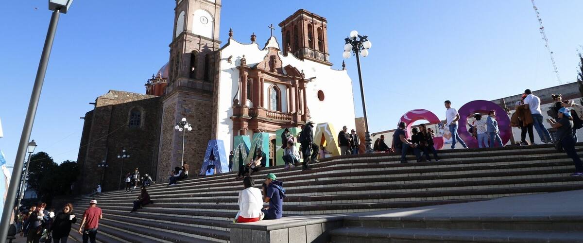 A historic church with a bell tower and steps leading up to it.
