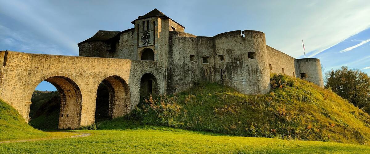 A medieval castle with a large archway and a tower.