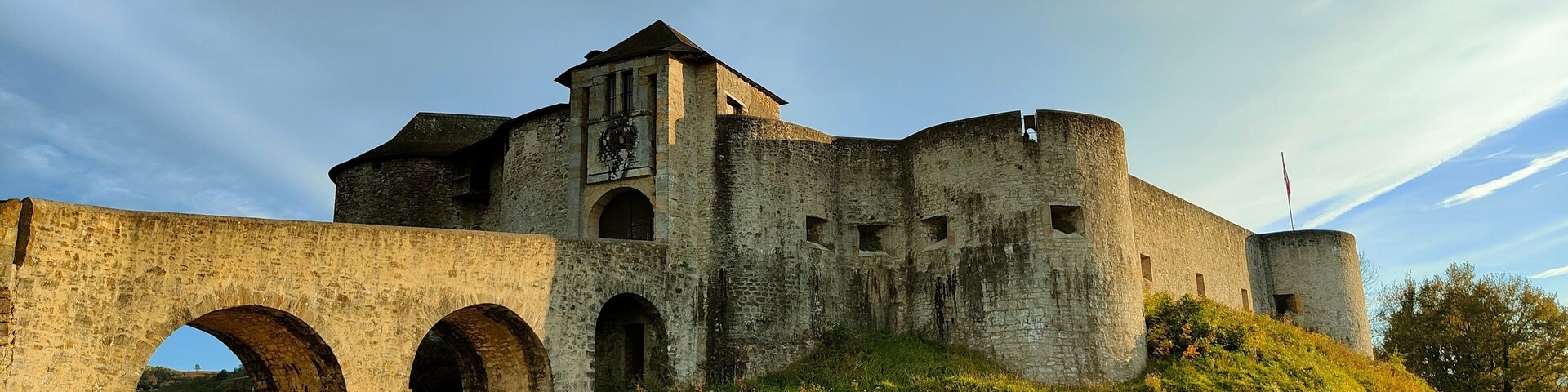 A medieval castle with a large archway and a tower.
