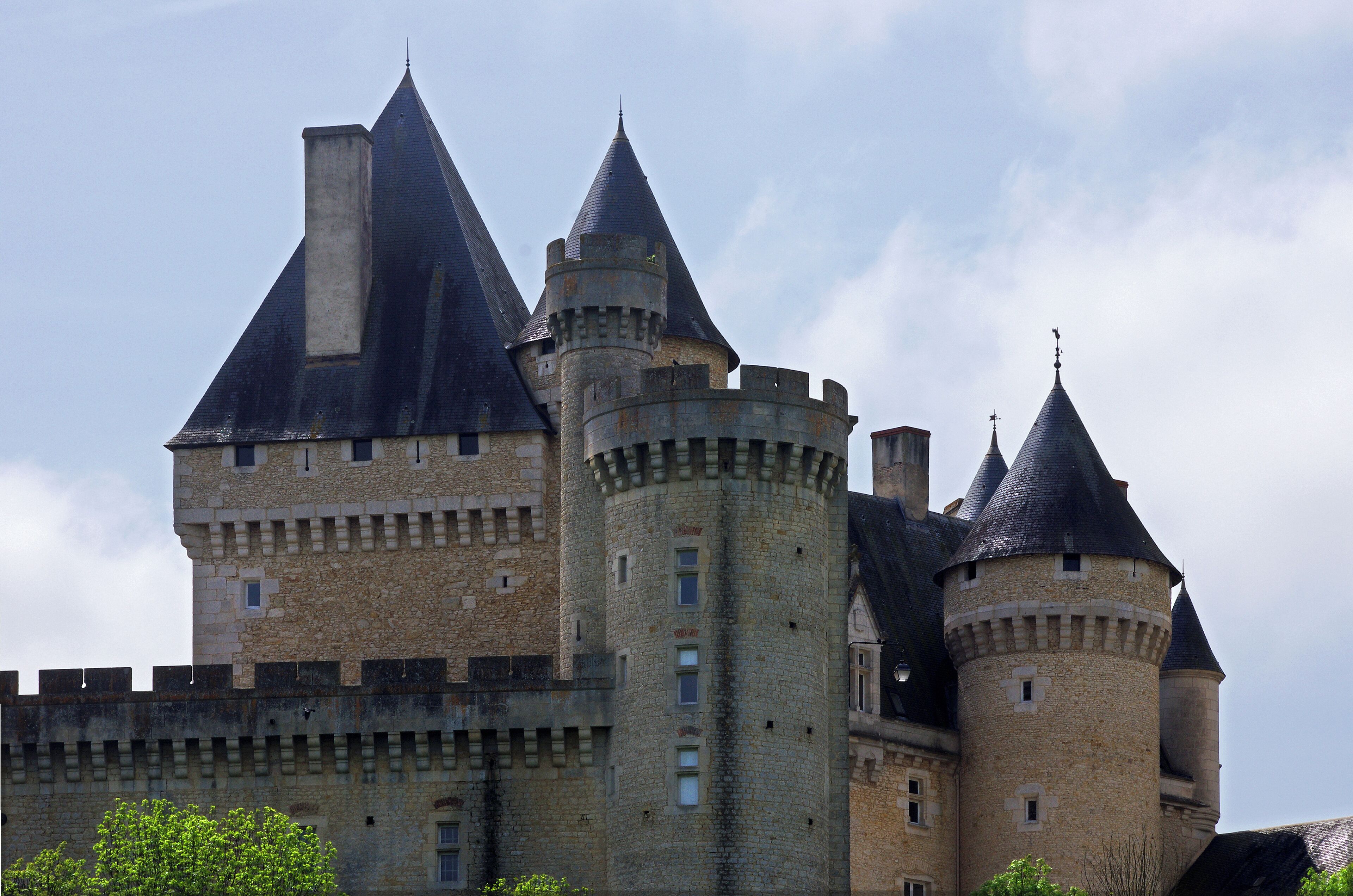 Le Pont-Chrétien-Chabenet (Indre). Château de Chabenet. L'imposant château de Chabenet domine la vallée de la Bouzanne. Le château de Chabenet est un lieu de mémoire du protestantisme en Berry. Le château a été construit pour Josselin Du Bois*, chambellan de Louis XI et seigneur de Montmorillon durant la deuxième partie du 15ème siècle. Dès 1463, Josselin du Bois est mentionné comme seigneur de Chabenet; la construction du château fut achevée vers 1471. Il jouera un rôle important dans les luttes qui opposèrent Louis XI aux grands féodaux: les Armagnac, dont le duc de Nemours et les Bourbons.
 Vers1480, le château est alors entouré de fossés larges de 8 toises (15,50 m). Il comprenait alors 14 tours et un donjon. Josselin du Bois aura une dizaine d'enfant de trois unions dont François, issu de la troisième, seigneur de Chabenet (décédé vers 1530), qui épousa Jeanne Brachet. Son fils, Jean du Bois dit "le Rouge"*, dissipa la fortune familiale et fut fréquemment emprisonné; notamment à la conciergerie du Palais. En 1544, Jean Du Bois,"le rouge", petit fils de Josselin, enlève la fille du procureur des causes royales de Poitiers. Il est condamné à mort et se réfugie chez Aubert de Montjohan qui le cache. Profitant de la situation celui-ci acquiert le château. Jean du Bois, "le Rouge", céda donc le château en 1544 à Aubert de Montjohan. La fille d'Aubert de Montjohan, Catherine, deuxième épouse du huguenot Jean de Pons, seigneur de Plassac, cousin d'Henri IV, chambellan et conseiller d'Etat du roi de Navarre, l'apporta ainsi à son mari. Le mobilier de la chapelle et le contenu de la bibliothèque laissent supposer qu'Aubert de Montjohan était déjà acquis aux idées de la Réforme. Cette lignée se poursuivit par Anne de Pons qui se maria trois fois et apporta successivement ses biens berrichons et Chabenet à ses trois époux, tous des Pierrebuffière. Le dernier de ses enfants, Charles de Pierrebuffière, proche de Gaston d'Orléans, mourra huguenot. Son arrière-petit-fils, Charles-Benjamin de Pierrebuffière, abjurera le protestantisme en 1685 à l'âge de 12 ans mais sa mère Catherine de Couraud, déjà veuve, maintiendra la foi protestante au château de Chabenet jusqu'à sa mort en 1735. Pendant les guerres de religion, il appartient à la maison protestante Pierre de Buffiere. Ce château reste propriété protestante de 1585 à 1735. Pris par la Ligue, puis reconquis par Henri de Navarre, le château de Chabenet fut étroitement associé à l'histoire du protestantisme berrichon de la région d'Argenton- sur-Creuse, place de sûreté accordée aux protestants par l'Edit de Nantes. Cette place se rendit au Roi en 1620 et, l'exercice public du culte y ayant été supprimé, Chabenet accueillit dorénavant les fidèles des environs. En 1635,ses défenses furent partiellement démantelées par Richelieu à la suite de l'Edit d'Alès*, mais plusieurs de ses tours, dont le donjon, gardent encore leurs charpentes d'origine, L'histoire protestante du château se clôturera en 1735 avec l'abjuration de la dame de Chabenet, Catherine de Couraud, obtenue sur son lit de mort à l'âge de 94 ans. Par la suite, et au travers de filiations féminines, Chabenet passera au marquis d'Asnières, au comte de Poix* puis à Joséphine de Boisé de Courcenay, décédée en 1924, dernière propriétaire descendant d'Aubert de Montjohan. Vendu comme bien d’émigré en 1793, il est racheté en 1803 par la famille de Poix. Louis Thomas Benjamin Comte de Poix le fait restaurer en 1850 puis le lègue à sa filleule Joséphine de Boisé. Ce domaine de près de 2 000 hectares qui va de Chabenet à la Rocherolles est acheté par M. Leclerc (charcutier), puis, en 1940 par M. Willeme* (industriel). M. Billon (Années 1970 : enduction plastique), M. Marek (années 1980 : école de langues) qui le restaura, M. Petrau (années 1990 : produits paramédicaux) et enfin Hapymag (années 2000 : séjours de vacances Le bruit a couru, en 1996, que Michael Jackson aurait racheté le château de Chabenet, il semble que ce fut un canular. Quoi qu'il en soit, le château est actuellement propriété de la société de loisirs et vacances Hapimag. Hapimag est une société par actions dont les actionnaires ne reçoivent pas de dividendes, mais un droit de jouissance des propriétés. Josselin du Bois fut un fidèle du roi Louis XI qui avait apprécié ses services pendant son exil en Brabant. Après son accession au trône, en 1461, il le nomma capitaine de Montmorillon, maréchal de ses logis et bailli des Montagnes d'Auvergne et lui fit très autoritairement épouser en deuxièmes noces Anne Asse, de riche et noble lignée. Josselin du Bois était alors veuf d'une première union sans doute non noble. Après la mort de Louis XI et celle d'Anne Asse, Josselin du Bois se remariera en 1486 avec Marguerite de Pérusse des Cars, veuve descendant d'une très ancienne lignée. Il décédera en 1498. Jean du Bois dit "le Rouge" aurait été surnommé le Rouge à cause d'un manteau rouge qu'il portait : "XXIII. Et en l'an auparavant, le Seigneur de Pringe, Aubert de Montjehan, sieur dudit Langon, bailla ledit Langon en échange à un gentilhomme du Berry, nommé Jean Dubois, dit le Rouge, à cause d'un manteau rouge qu'il portoit. Les autres l'appeloient de Chabenet, et lequel lieu de Chabenet demeura en contre-échange audit Sieur de Pringe. Et durant que ledit Dubois étoit Seigneur dudit Langon, lui et ledit François Suzenet, Seigneur du Bois-Lambert, firent échange. C'est pourquoi tout le droit du grand four demeura audit Dubois et tout le droit de terragerie demeura audit Suzenet et trois septiers et demi qu'il bailloit annuellement au Seigneur de Langon. Et lequel Seigneur de Langon nommé Jean Dubois , ne posséda qu'un an ou deux le Langon et, quant à ses moeurs et conversation, je me tais......" (Archives historiques du Bas-Poitou - Chroniques fontenaisiennes - Fontennay-le-Comte - 1841 - pp45 et 46) Édit de grâce d'Alès (28 juin 1629) : Après avoir vaincu les protestants à La Rochelle, Louis XIII publie l'édit de grâce d'Alès qui oblige les protestants du royaume à renoncer à leurs places de sûreté et au droit de tenir des assemblées. Willème est une marque française de camions. Créée après la Première Guerre mondiale en 1919 à Nanterre, la marque disparaîtra en 1960. Louis-François-Vincent, comte de Poix, Seigneur de Marécreux de la Noühe, de la Barre en Ciron, lieutenant-colonel d'infanterie, Chevalier de St Louis. Il épousa en 1769, Elisabeth de Pierre Buffière, dame de Chabenet. Il fût emprisonné pendant la Révolution à Châteauroux et mourut en 1814, au château de Marécreux. De cette union, il aura: Thomas-Louis-Benjamin, Baron de Poix, Chevalier de Malte en 1773 puis époux à Paris le 27 novembre 1810 de Joséphine d'Andigné de la Châsse. Les deux moururent au château de Chabenet après avoir eu : Louis-Thomas Benjamin, comte de Poix, Châtelain de Chabenet, mort sans alliance en 1878 et Marie-Louise-Léontine de Poix, qui épousa le Comte Stanislas de Boisé de Courcenay. De cette dernière union , naquit, vers 1840,Joséphine de Boisé, qui devint ainsi l'héritière du château de Chabenet, à la mort de son oncle.Elle même mourut à l'âge de 84 ans sans héritiers directs. Sa succession fera l'objet d' un contentieux juridique dont la presse se fera l'écho. (H. Alain Brissaud a achevé en 1996 une importante étude sur Josselin du Bois et le château de Chabenet intitulée "Six siècles à Chabenet". L'exemplaire que l'auteur a remis à la Bibliothèque de la Société d'Histoire du Protestantisme Français est conservé sous la cote br. 110.)