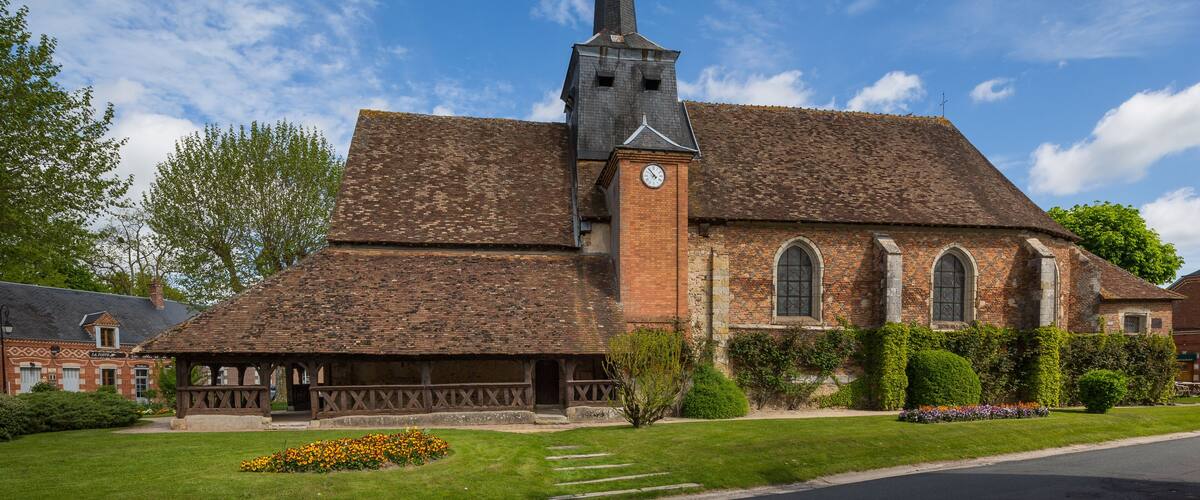 A church with a tall steeple and a clock tower.