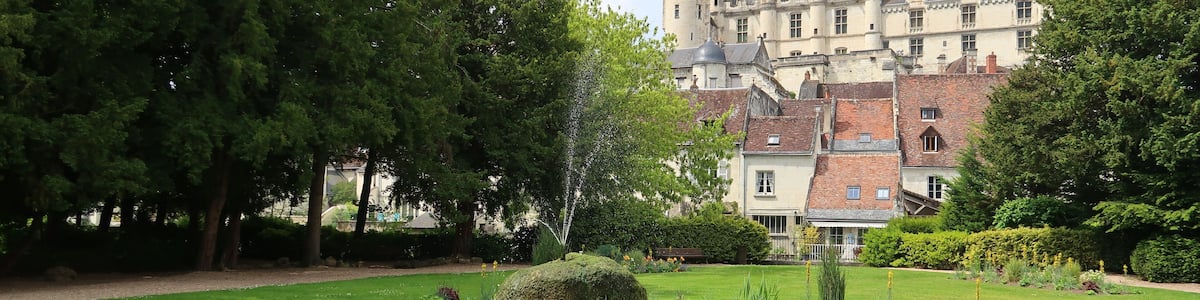 Logis royal du château de Loches vu depuis un jardin public, avec une fontaine (France)