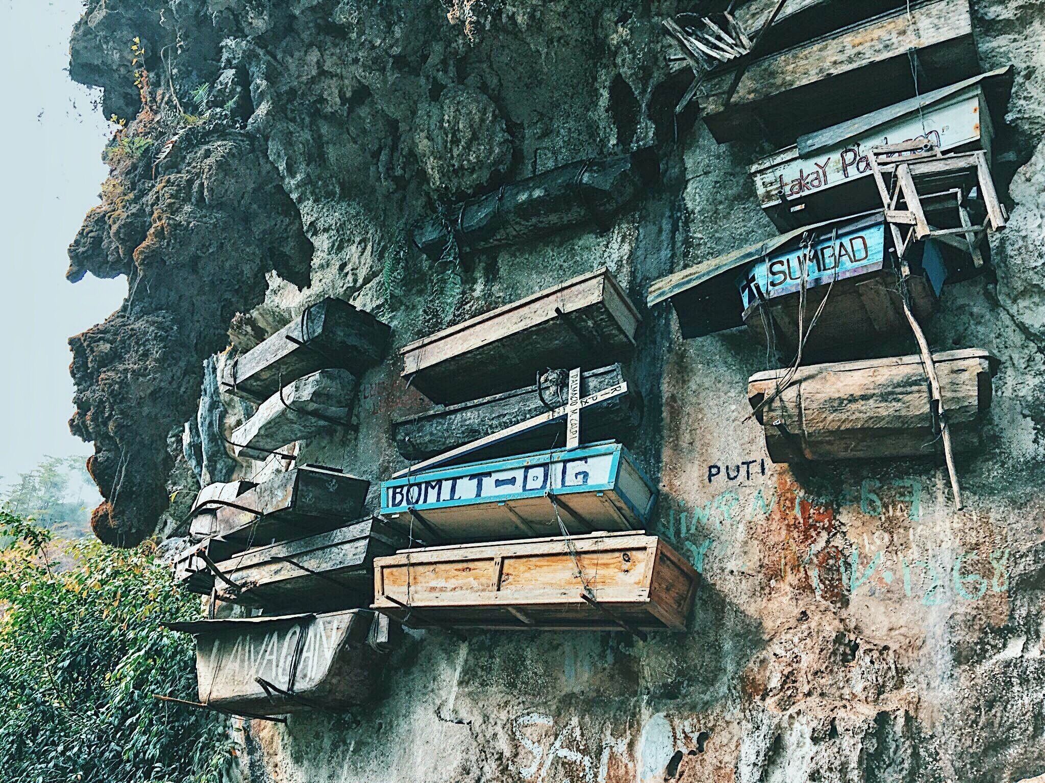 Wooden platforms attached to a rocky cliff.