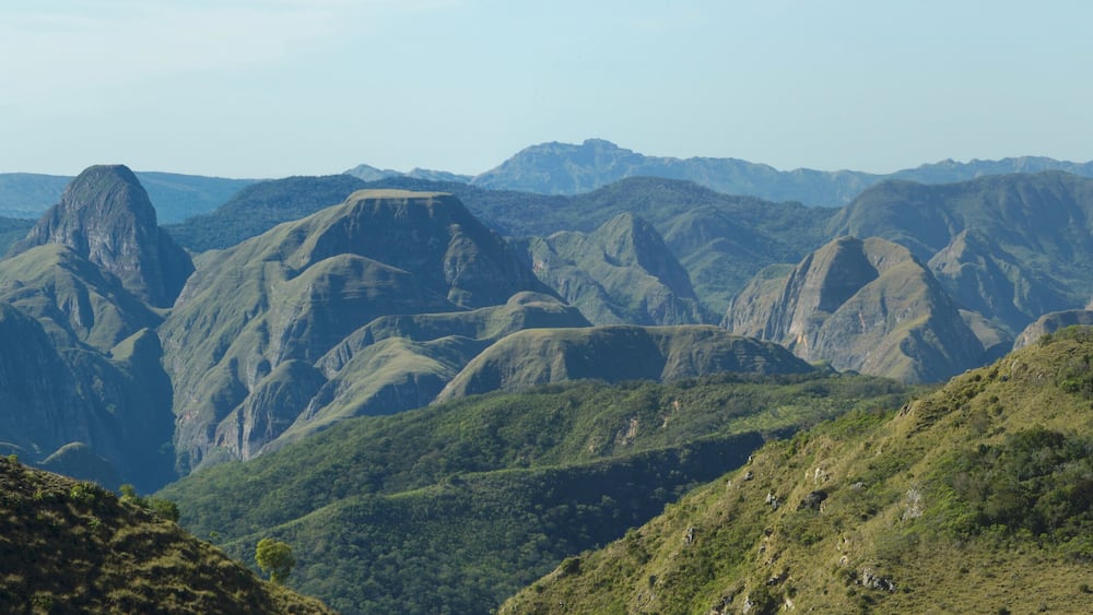 A mountainous landscape with rugged peaks and lush green valleys.