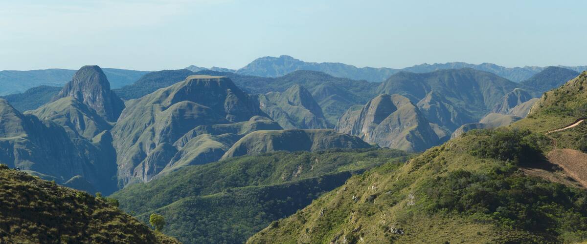 A mountainous landscape with rugged peaks and lush green valleys.