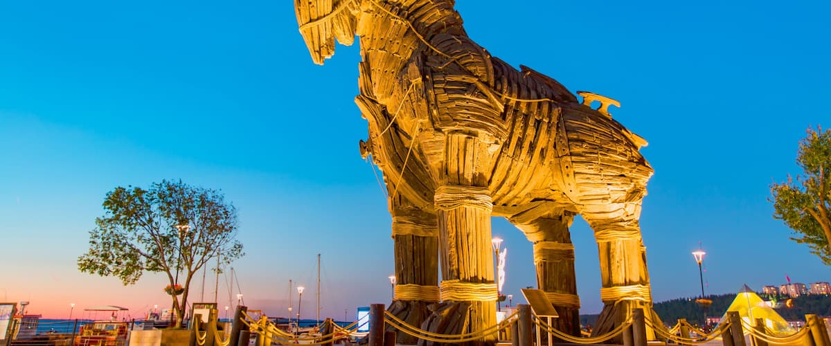A large, illuminated horse sculpture at dusk.