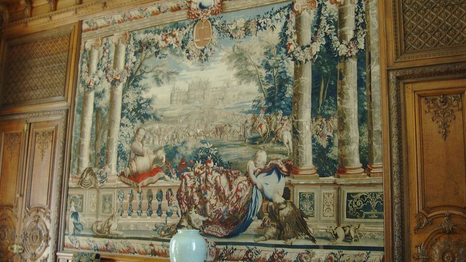 A detailed mural with classical figures, columns, and a vase.