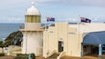 A museum with a white dome and flags.