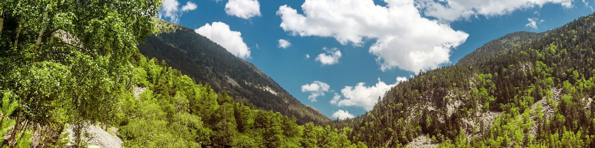 women hiker with backpack on mountain trail in the Pyrenees mountains