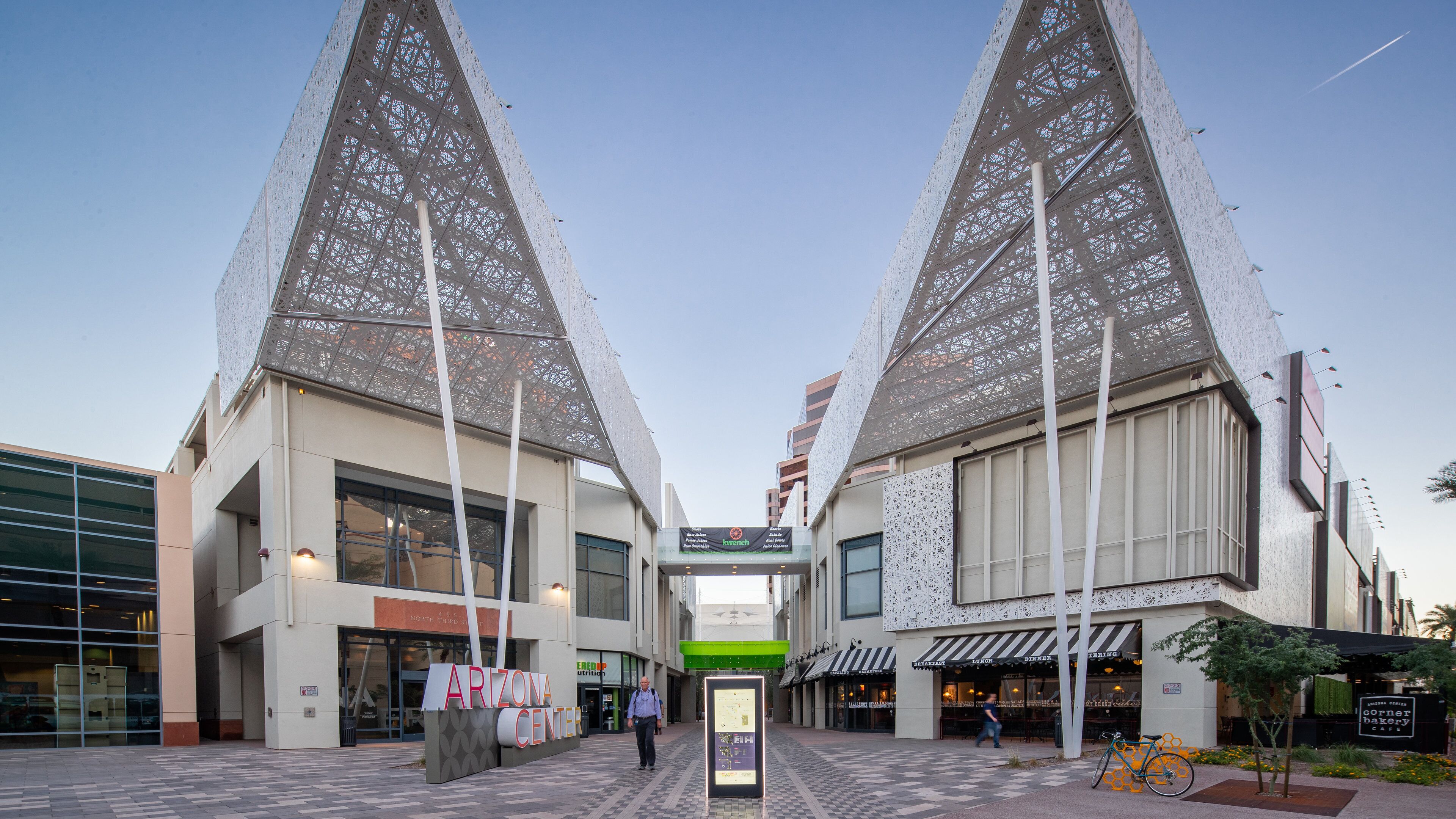 A modern building with a unique lattice facade and a sign reading "ARIZONA CENTER".