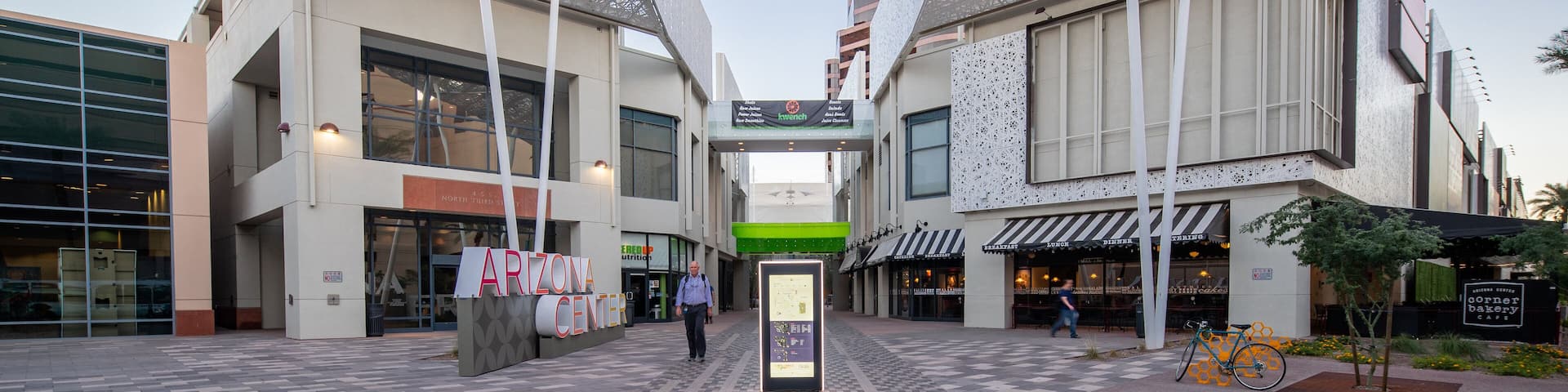 A modern building with a unique lattice facade and a sign reading "ARIZONA CENTER".