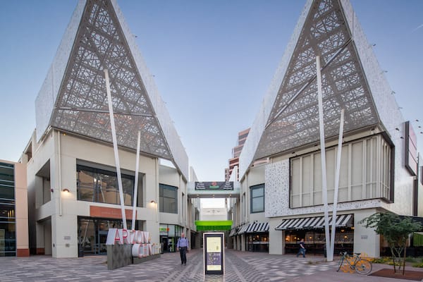 A modern building with a unique lattice facade and a sign reading "ARIZONA CENTER".