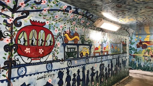 Scene depicting in underground passageway at train station in Auvers