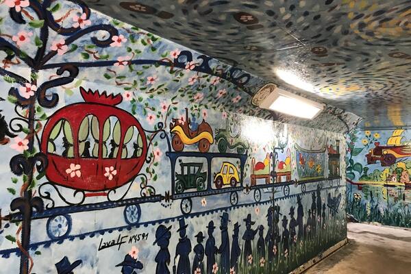 Scene depicting in underground passageway at train station in Auvers