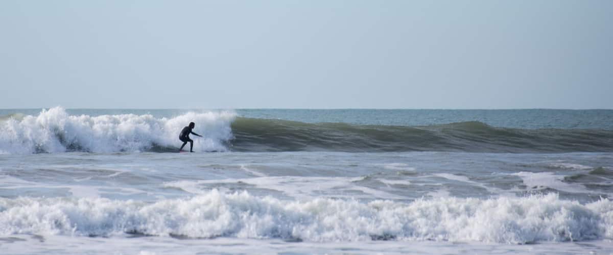 A surfer riding a wave in the ocean.