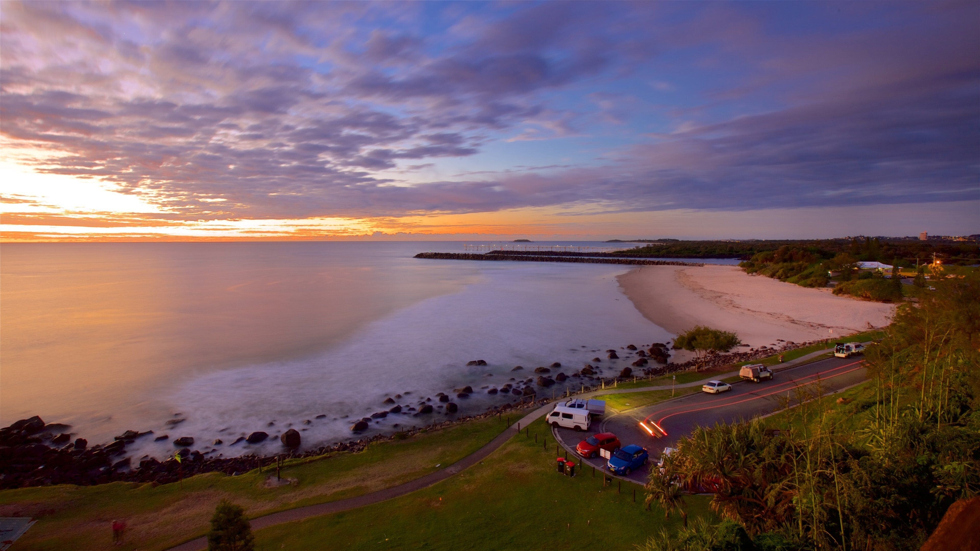 Point Danger showing a sunset, a sandy beach and general coastal views