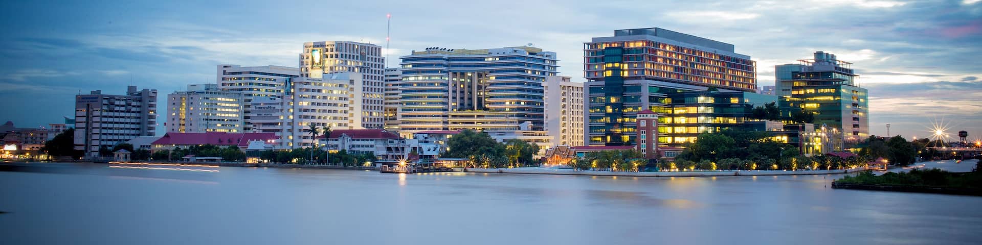 Siriraj Hospital A major government hospital in Bangkok, Thailand situated by the Chao Phraya River with twilight light.