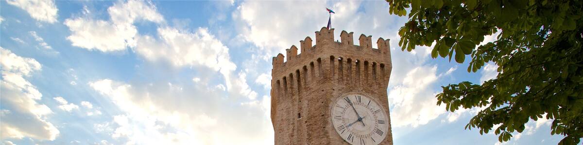 Tower of Gualtieri featuring heritage architecture and a sunset