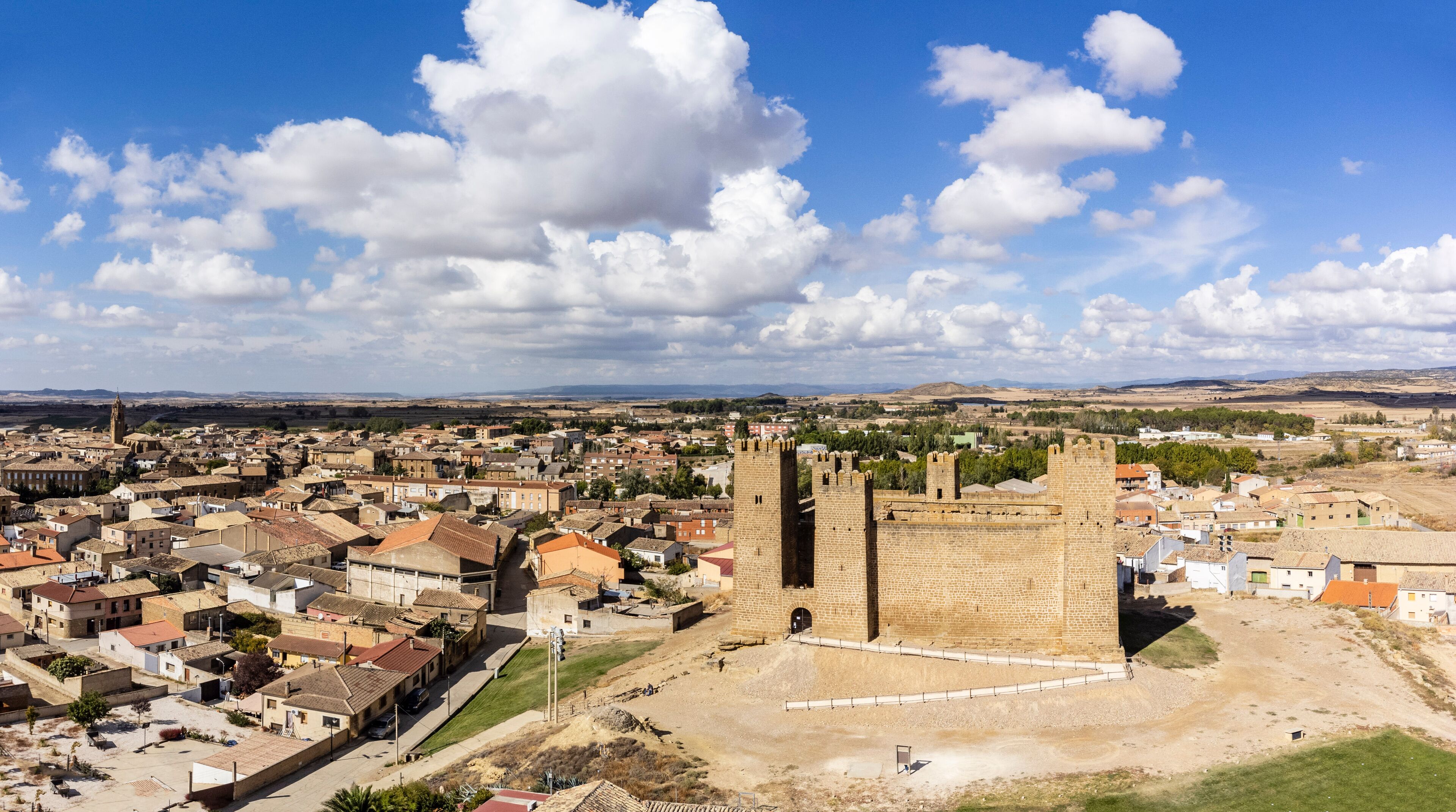 A historic town with a prominent castle, cobblestone streets, and a mix of traditional and modern architecture.