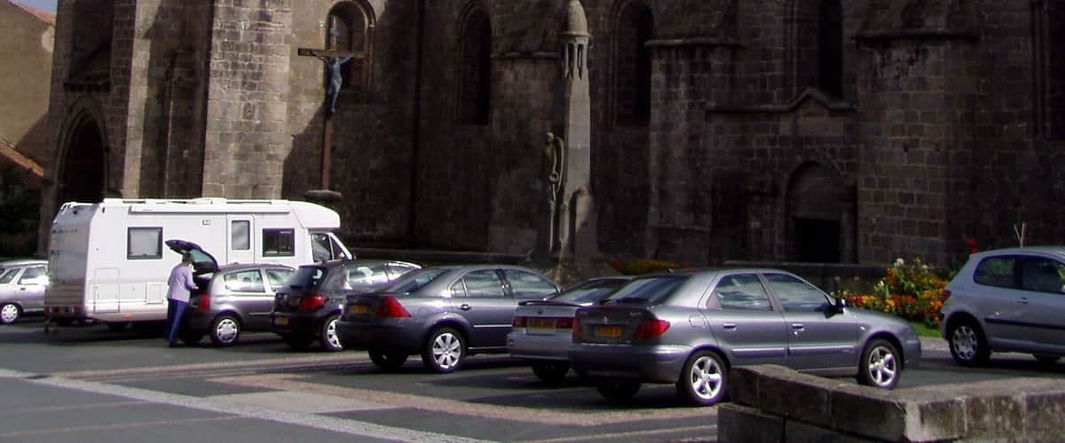 A historic church with a tall tower and a smaller spire.
