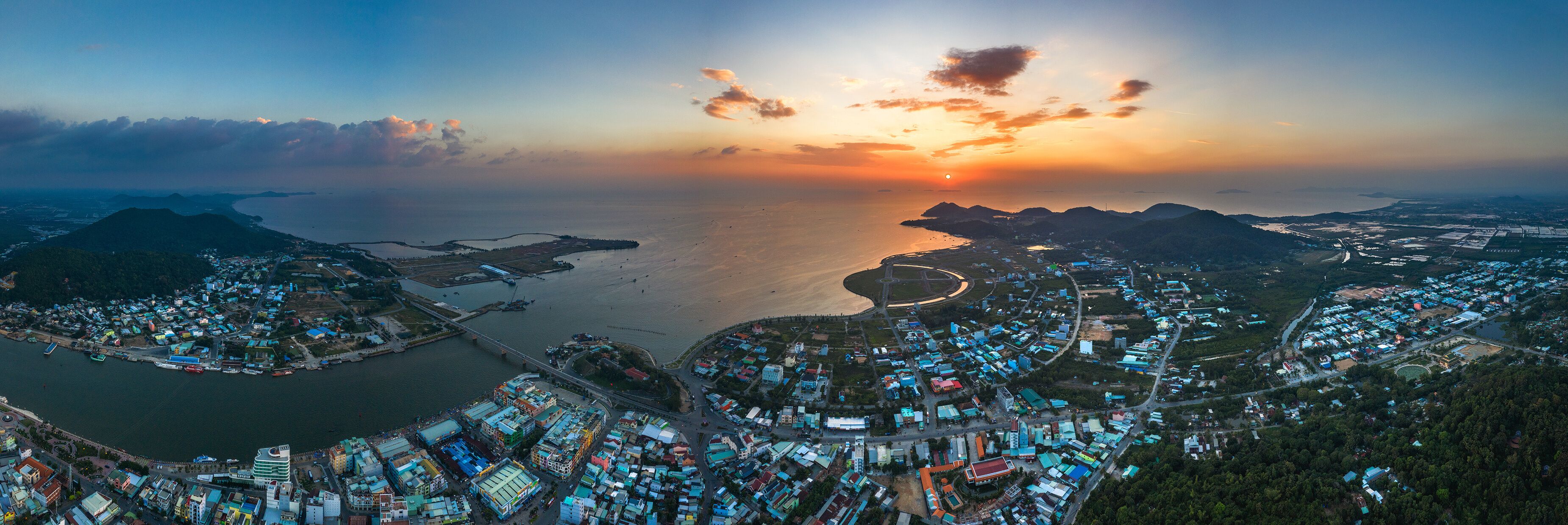 Top view aerial of Ha Tien City with development buildings, transportation, energy power infrastructure. Famous tourist city of Vietnam, sharing the border with Cambodia
