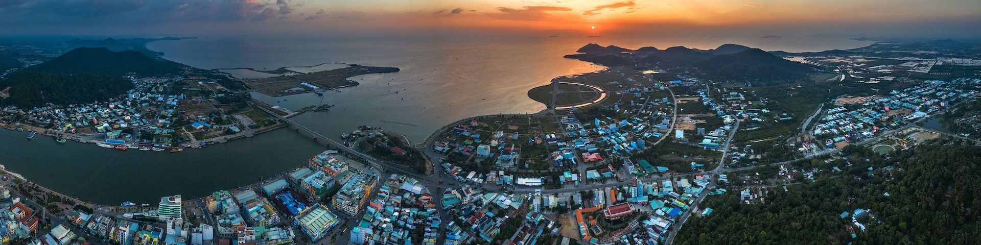 Top view aerial of Ha Tien City with development buildings, transportation, energy power infrastructure. Famous tourist city of Vietnam, sharing the border with Cambodia