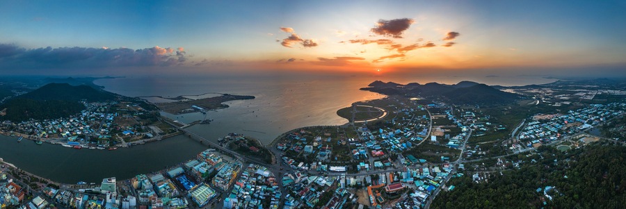 Top view aerial of Ha Tien City with development buildings, transportation, energy power infrastructure. Famous tourist city of Vietnam, sharing the border with Cambodia
