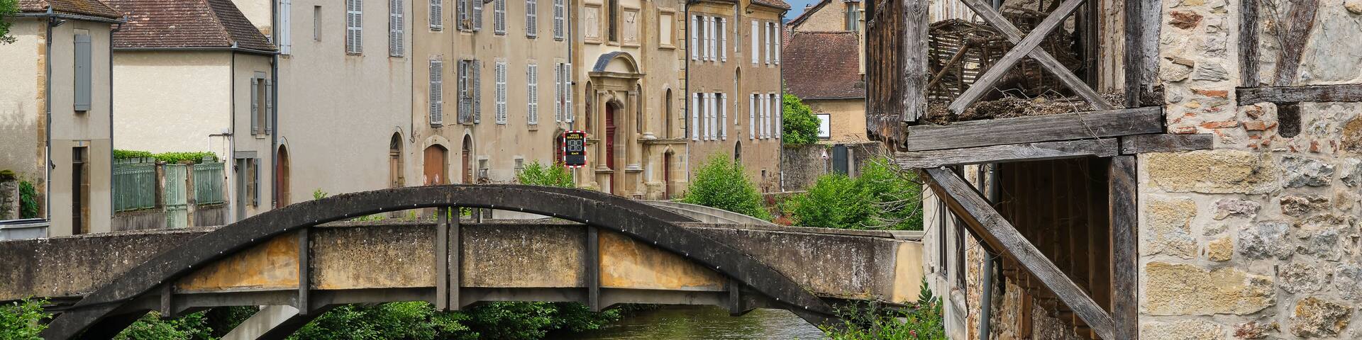 View at the Récollets Church and the Bave river in the village of Saint-Céré Lot Occitanie in Southern France under a cloudy and stormy sky in summer.