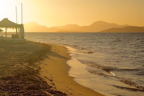 Tigaki Beach featuring a beach and a sunset