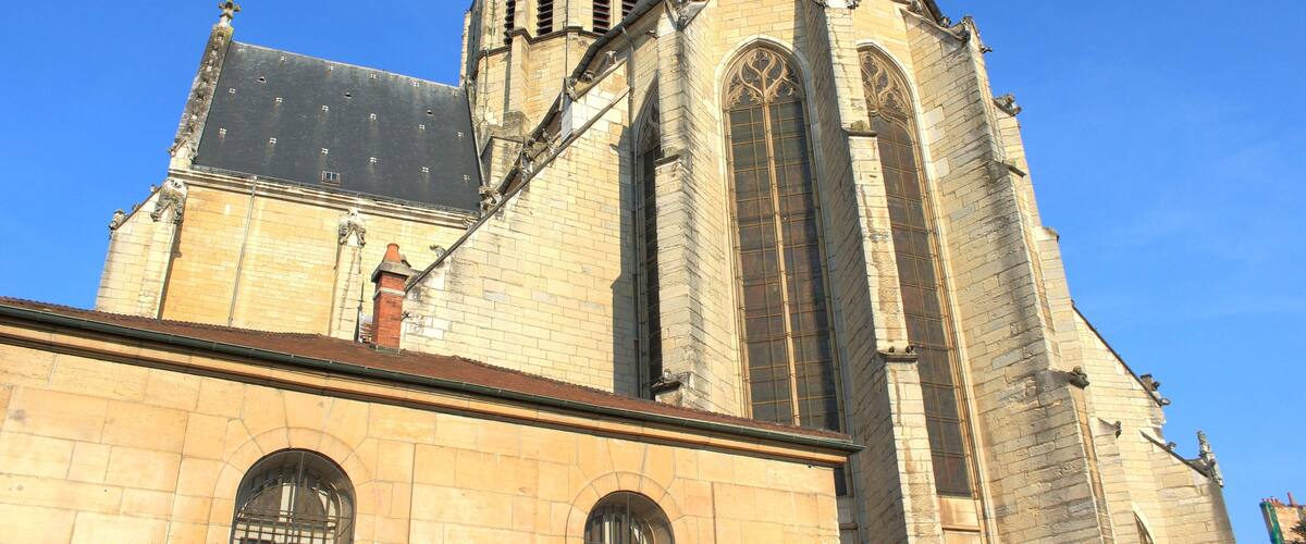 A historic church with a prominent bell tower and arched windows.