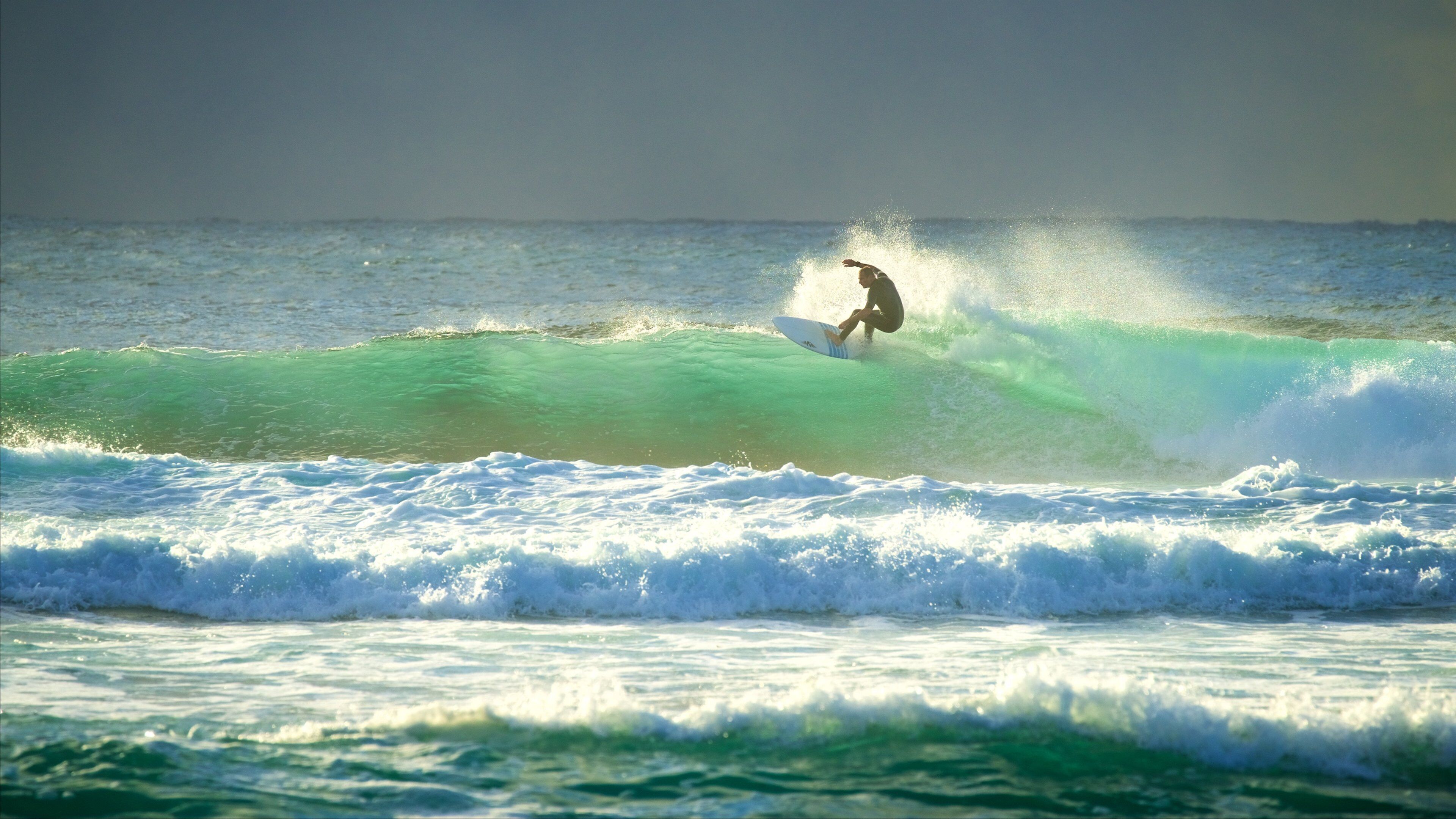 A surfer riding a wave in the ocean.