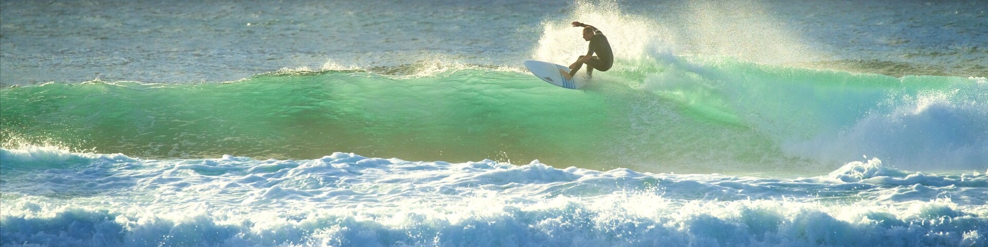 A surfer riding a wave in the ocean.