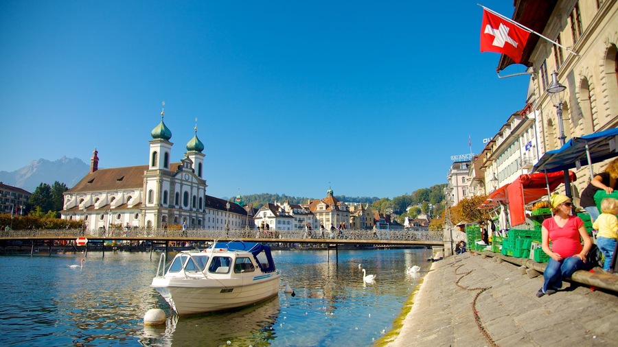 Old Town Lucerne showing boating, heritage architecture and a church or cathedral