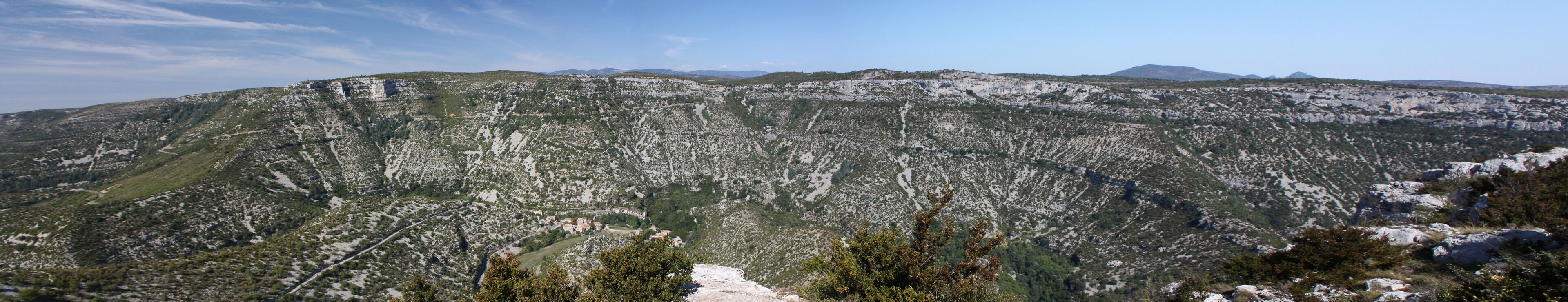 A mountainous landscape with rocky terrain and sparse vegetation.