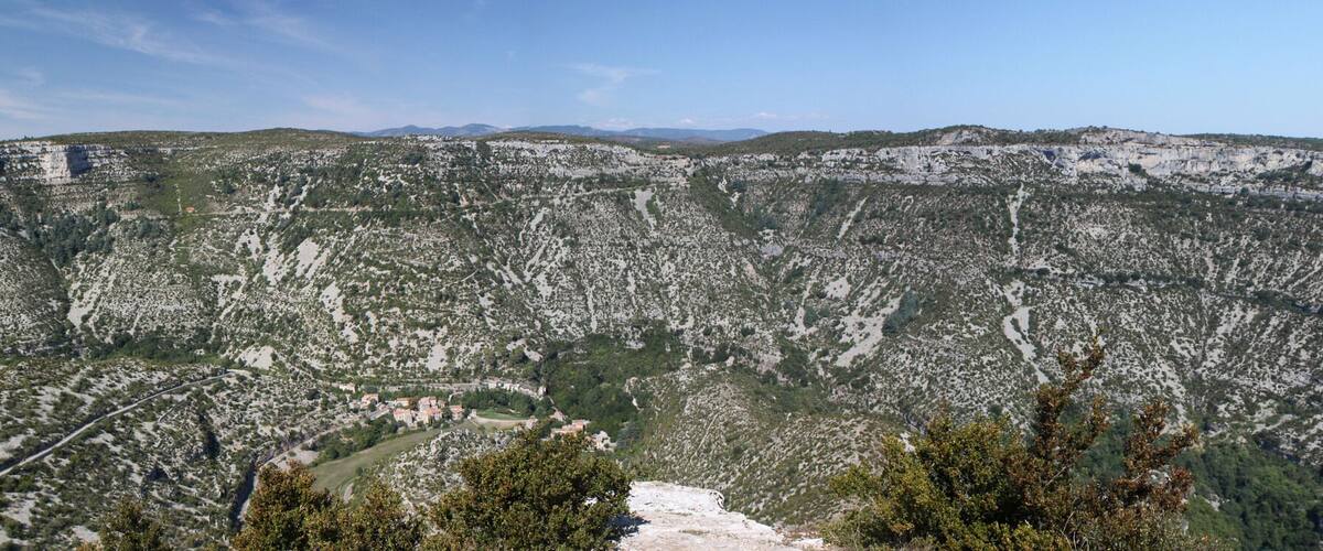 A mountainous landscape with rocky terrain and sparse vegetation.
