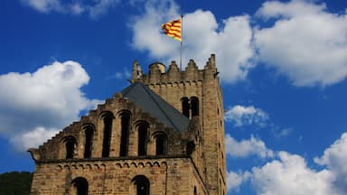 A historic stone tower with a flag.