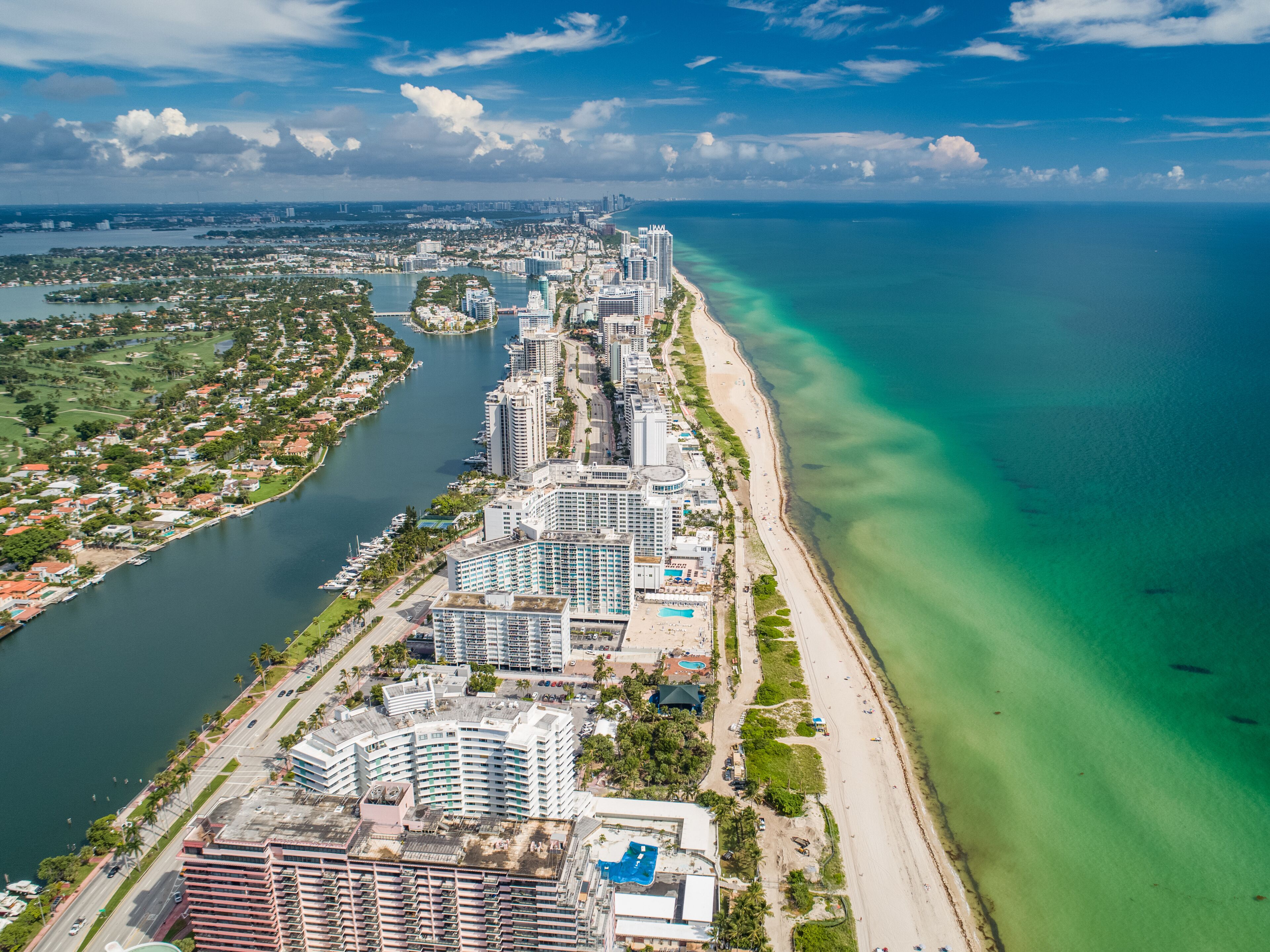 Aerial Miami Beach along Collins Avenue mid beach waterway with Yacht Marina and high rise condos