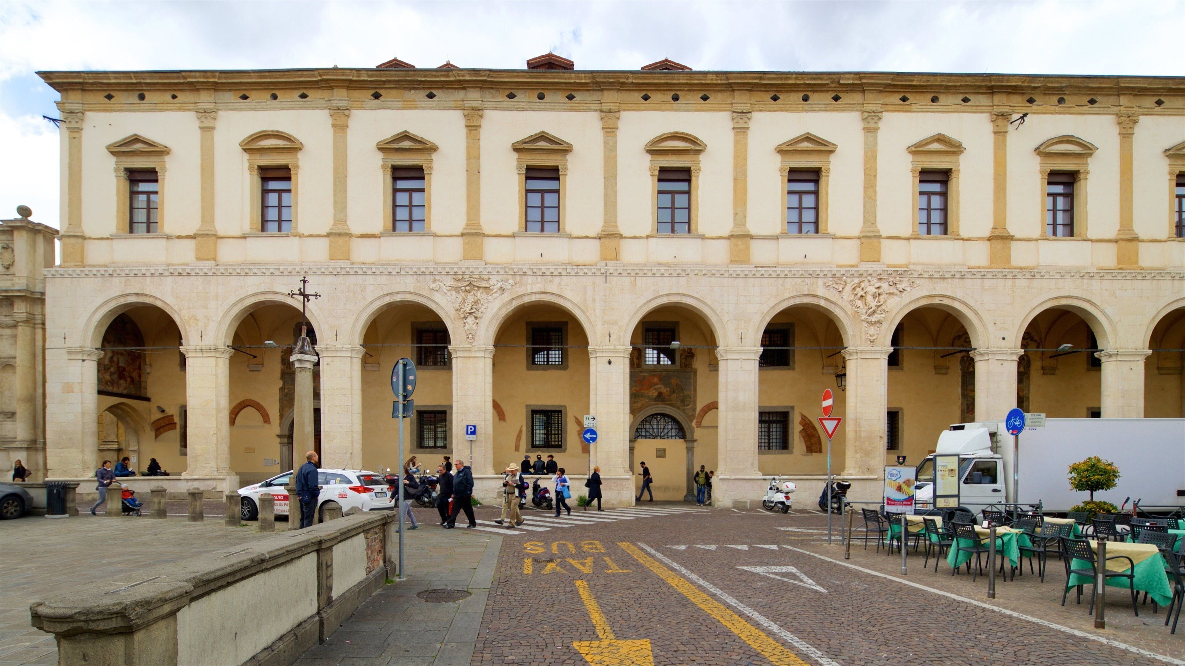 Piazza del Duomo featuring street scenes and heritage elements as well as a small group of people