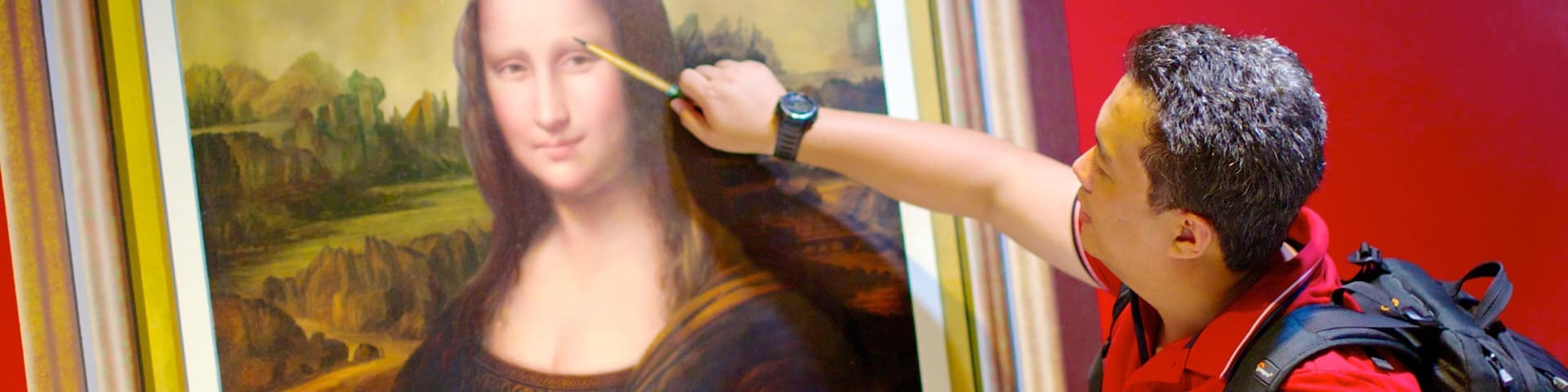 A person pointing at the Mona Lisa painting.