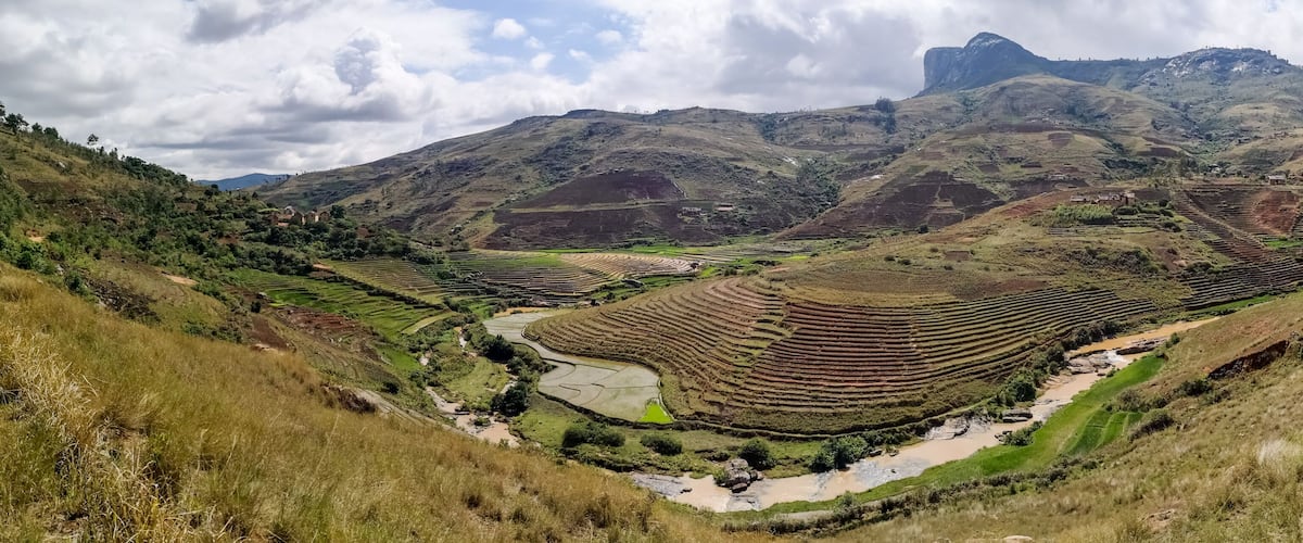 Terraced rice fields, a river, and mountains.