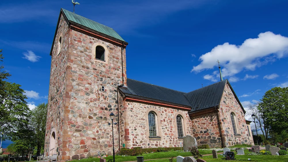 Old sweden church with cemetery in small town near Stockholm - Vallentuna, vivid natural outdoor Sweden background