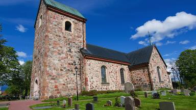 Old sweden church with cemetery in small town near Stockholm - Vallentuna, vivid natural outdoor Sweden background