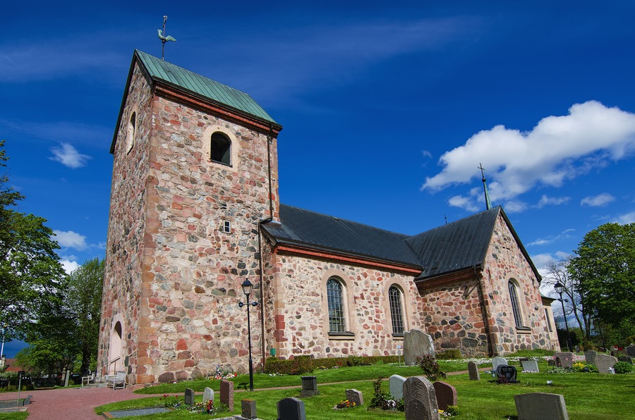 Old sweden church with cemetery in small town near Stockholm - Vallentuna, vivid natural outdoor Sweden background