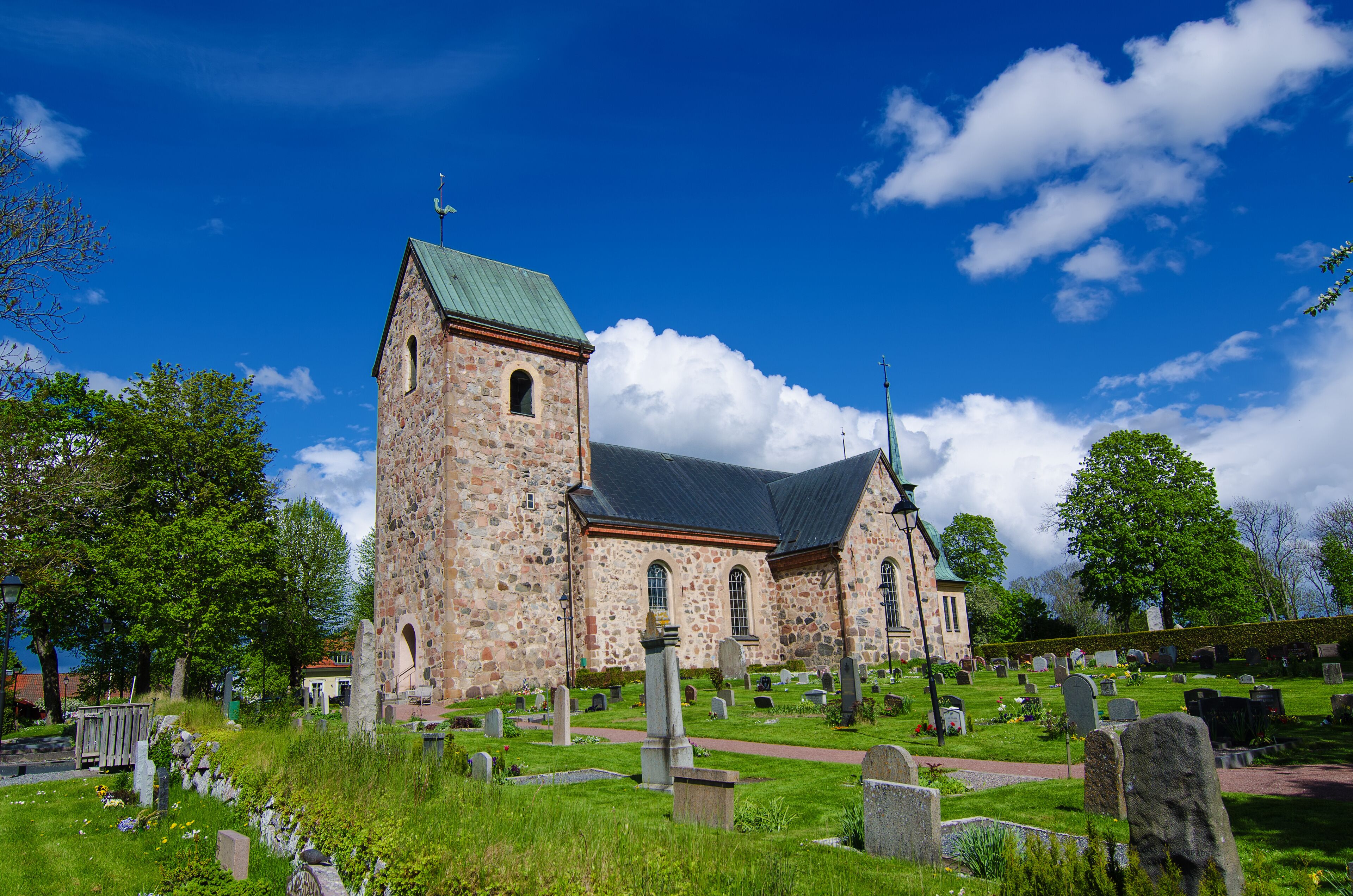 Old sweden church with cemetery in small town near Stockholm - Vallentuna, vivid natural outdoor Sweden background