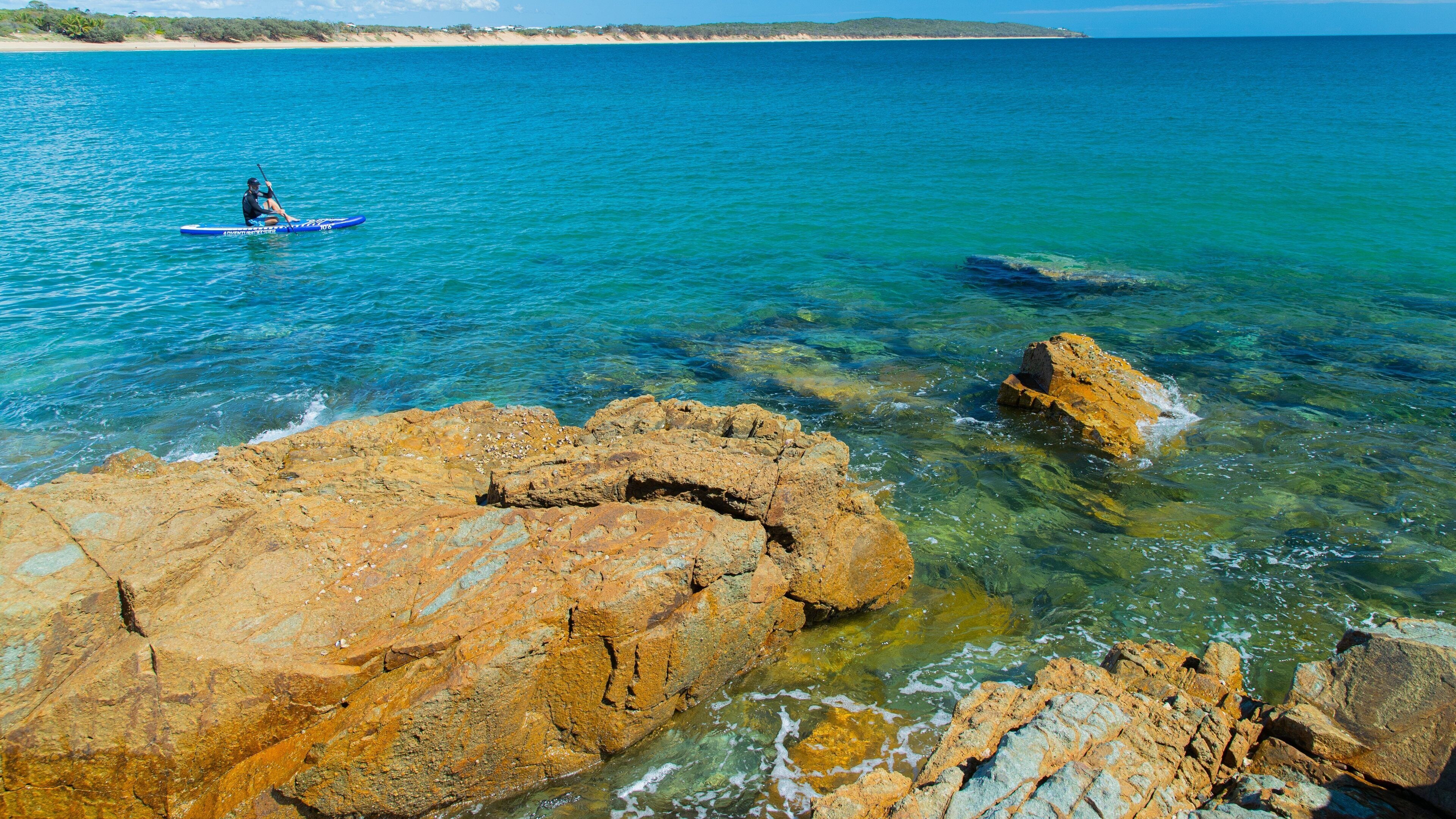 Agnes Water Beach showing general coastal views, rugged coastline and kayaking or canoeing
