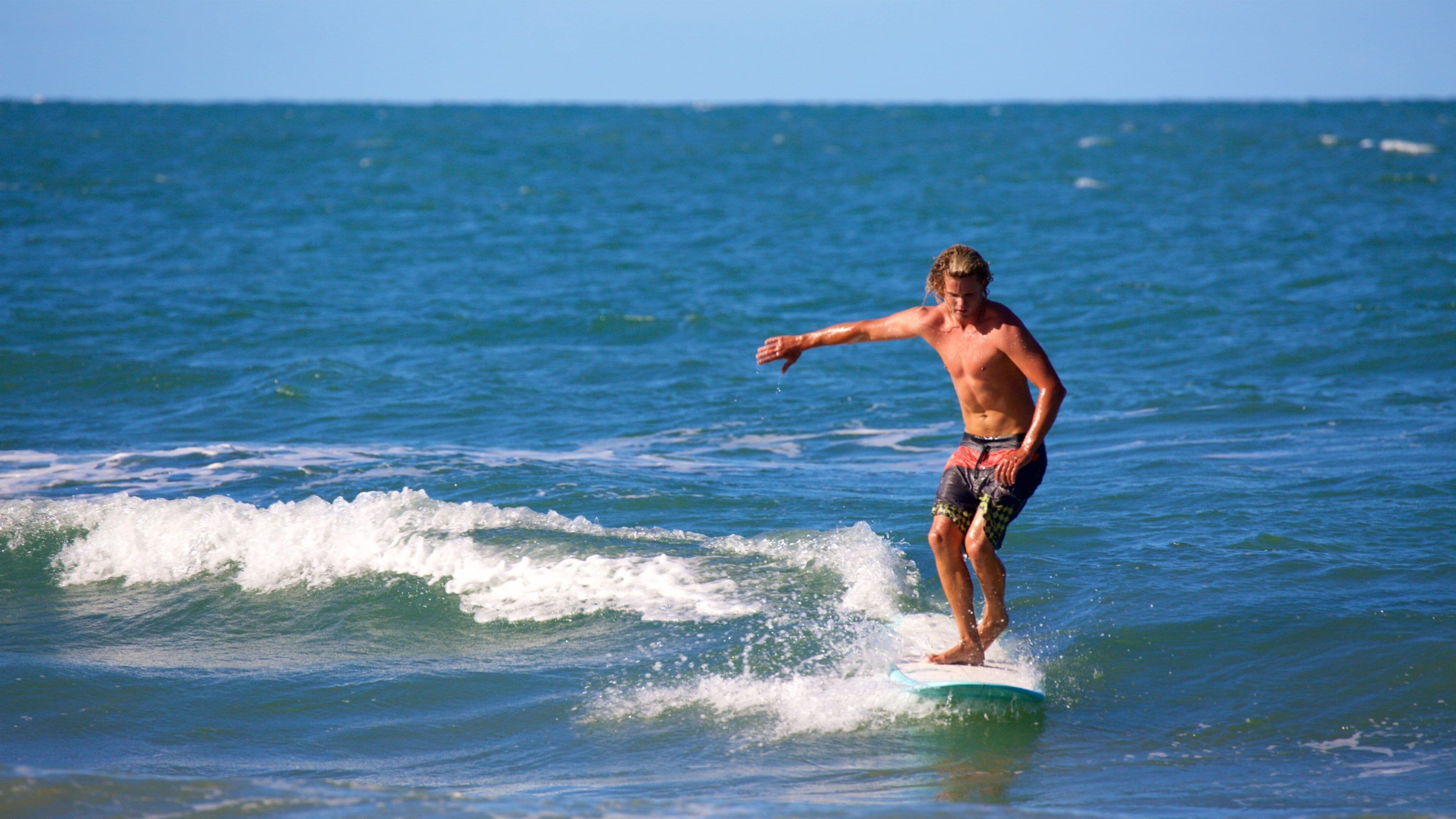 Agnes Water Beach which includes surf and surfing as well as an individual male