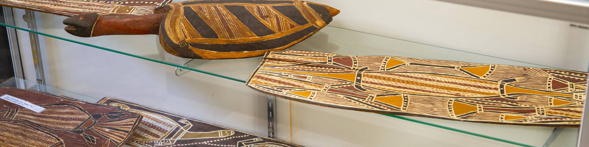A display of decorated narrow shields.